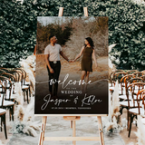 Custom personalized wedding welcome sign displayed on a wooden easel at an outdoor ceremony
