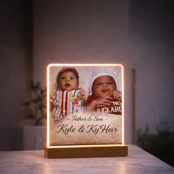 Personalized illuminated LED photo frame featuring two baby photos, custom names and a wooden display base
