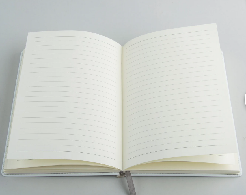 Open custom journal showing the interior writing pages
